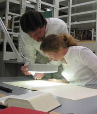 Amy Myshrall and Timonthy Brown checking their transcription on a Codex Sinaiticus leaf at Leipzig University Library.